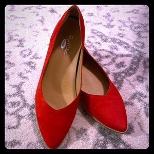Red suede Dr. Scholl’s flats with wooden heel.